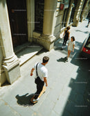 Skateboarding Youths Walking on Sunny City Street Sidewalk