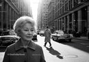 Elegant Elderly Woman Walking on City Street in Black and White