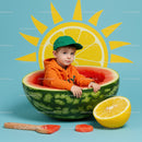 Little boy sitting inside a giant watermelon bowl