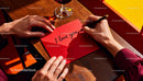 Writing a heartfelt love note on a red envelope