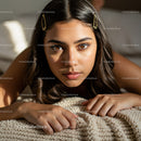 Close-up Portrait of Young Woman with Brown Eyes and Hair Clips in Cozy Setting