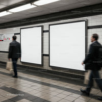 Business commuters passing blank poster frames in subway