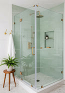 Modern Glass Shower with Mint Green Tiles and Brass Fixtures