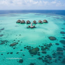 Overwater Bungalows on a Tropical Island with Clear Turquoise Water