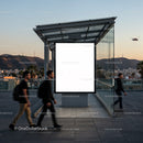 Urban sunset with blank billboard and moving pedestrians