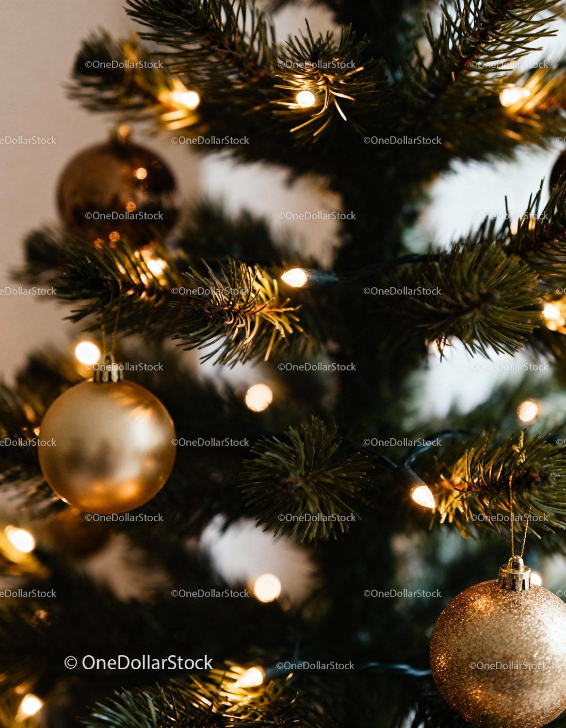 Close-up of Christmas Tree with Warm Lights and Gold Ornaments