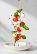 Fresh Caprese Ingredients Falling onto Gold Fork
