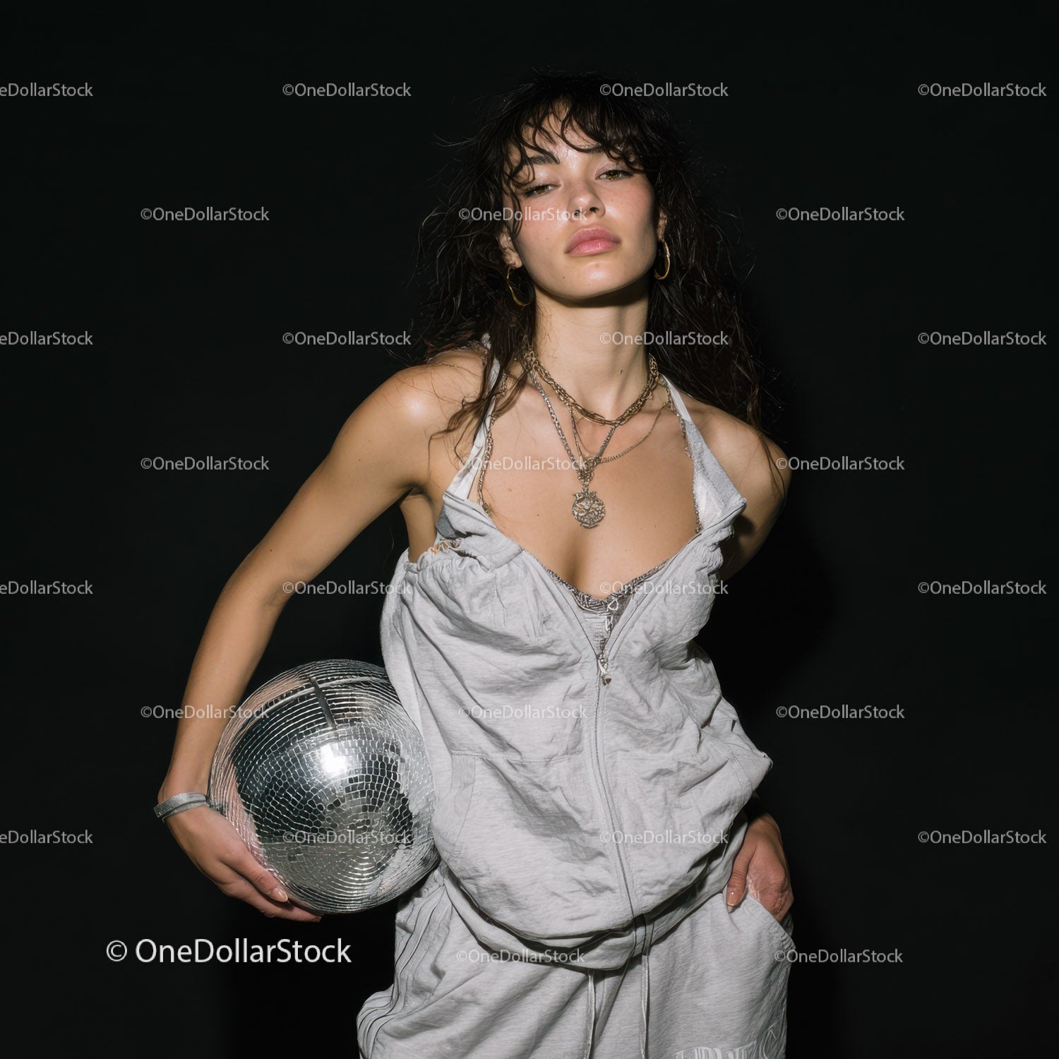 Stylish Woman in Metallic Outfit Holding Disco Ball for Modern Fashion