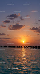 Beautiful Sunset Over Calm Ocean with Overwater Bungalows