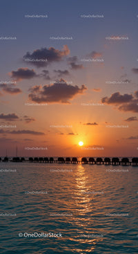 Beautiful Sunset Over Calm Ocean with Overwater Bungalows