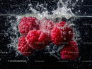Vibrant Raspberries Splashing into Water with Fresh Juiciness