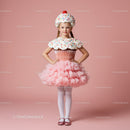 Little girl wearing playful cupcake costume standing
