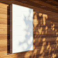 Blank vertical billboard on warm wooden wall exterior
