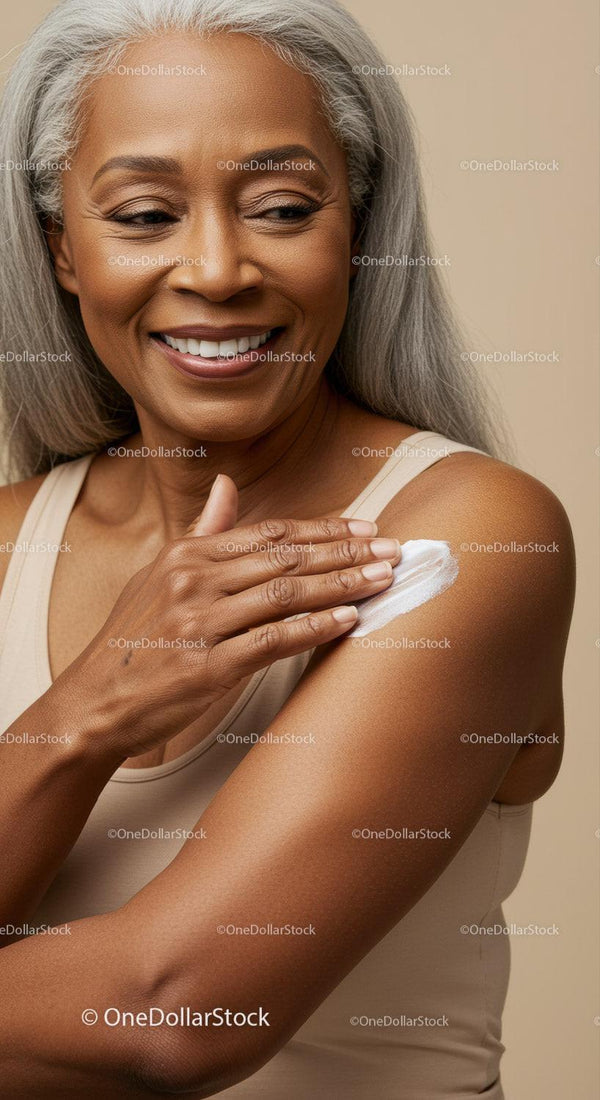Smiling Elderly Woman with Gray Hair Applying Lotion to Shoulder