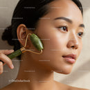 Close-Up Portrait of Young Woman with Jade Roller and Flawless Skin