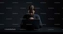 Thoughtful Woman at Laptop in Dark Modern Workspace