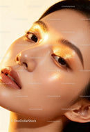 Close-up of woman with glowing golden makeup