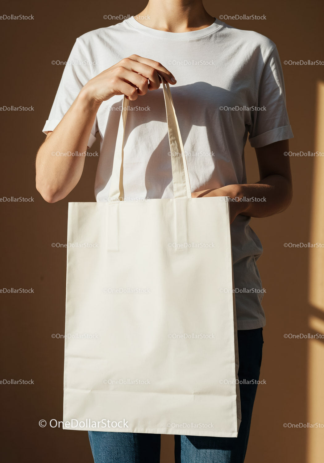 Person holding blank white canvas tote bag in sunlight