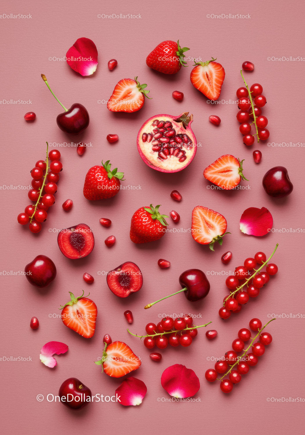 Fresh red berries and fruits arranged on pink background