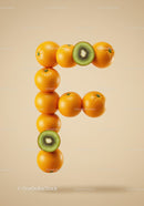 Creative letter F made of oranges and kiwi slices