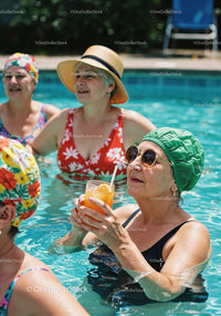 Elderly Women Relaxing and Drinking Refreshing Drinks in Pool
