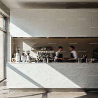 Minimalist cafe counter with modern baristas serving coffee