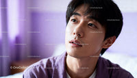 Thoughtful young man gazing quietly indoors
