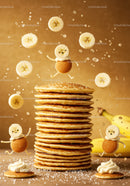 Stack of golden pancakes with playful banana characters