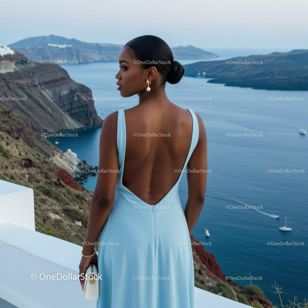 Elegant woman overlooking serene coastal landscape