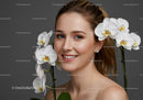 Elegant Woman with White Orchids in Front of a Gray Background