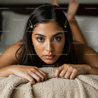 Beautiful Young Woman with Hair Clips Resting on Cozy Blanket