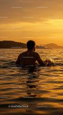 Serene Man Swimming in Ocean During Vibrant Sunset