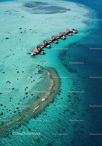 Overwater Bungalows in Turquoise Ocean with Scenic Coastal View