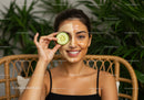 Young Woman with Cucumber and Facial Mask Engaged in Skincare Routine