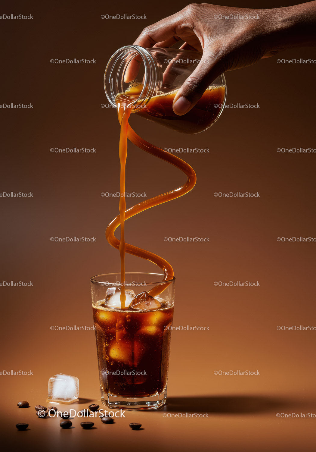 Iced coffee pouring in artistic swirl over ice cubes