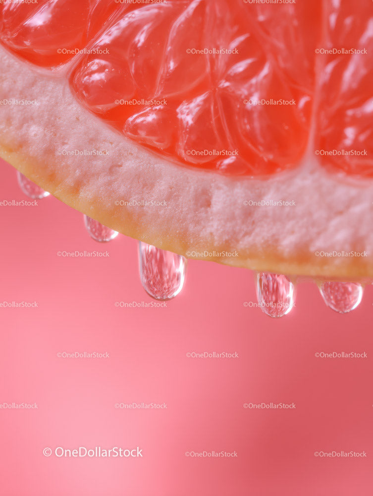 Close-up of Juicy Pink Grapefruit Slice with Water Droplets