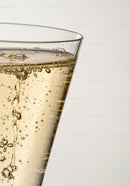 Close up of sparkling golden drink in clear glass