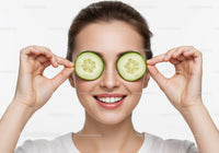 Joyful Woman Holding Cucumber Slices in Bright White Studio