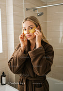 Woman Applying Under Eye Patches in Bathroom for Skincare Routine