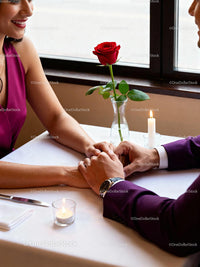 Couple holding hands during romantic candlelit dinner