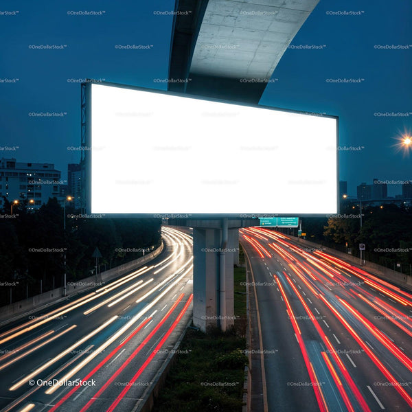 Illuminated blank billboard over busy city highway at dusk JPG Mockup Image