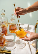 Elegant Orange Cocktail in Stylish Glass with Gold Spoon and Luxe Decor