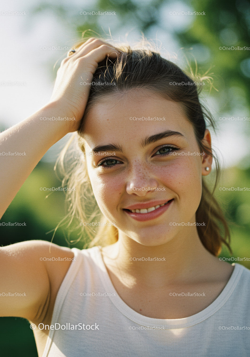 Young Woman Smiling Outdoors in Bright Summer Sunlight