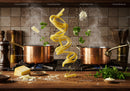 Fresh pasta with herbs and cheese in rustic kitchen