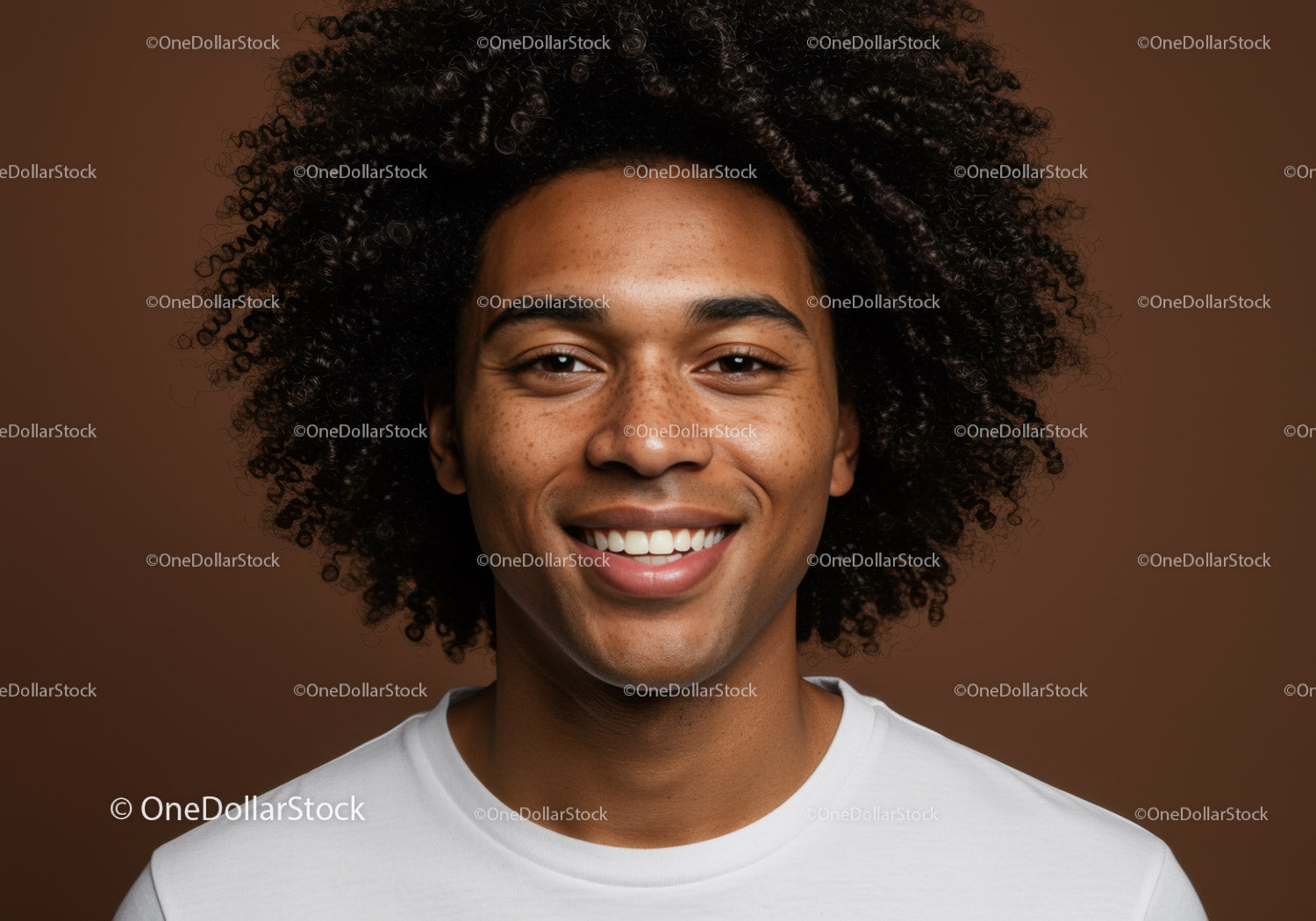 Portrait of a Smiling Young Man with Curly Hair and Freckles