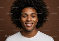 Portrait of a Smiling Young Man with Curly Hair and Freckles