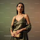 Elegant Woman in Gold Satin Dress with Accessories in Modern Fashion Setting