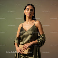Elegant Woman in Gold Satin Dress with Accessories in Modern Fashion Setting