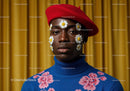 Stylish man in red beret with daisy face art