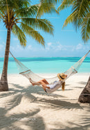 Relaxing Woman in Hammock on Tropical Beach with Palm Trees and Ocean